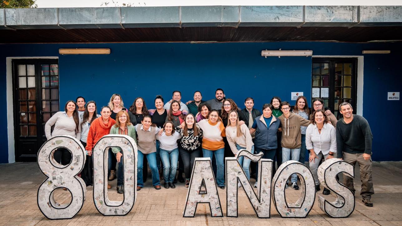 comunidad del liceo de aiguá con cartel de ochenta años